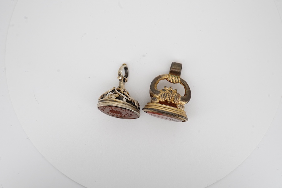 Two antique gilt metal and carnelian set fob seals, one matrix carved with the name 'James', the other 'Lamova' with a rose, 27mm et infra. Condition - poor to fair